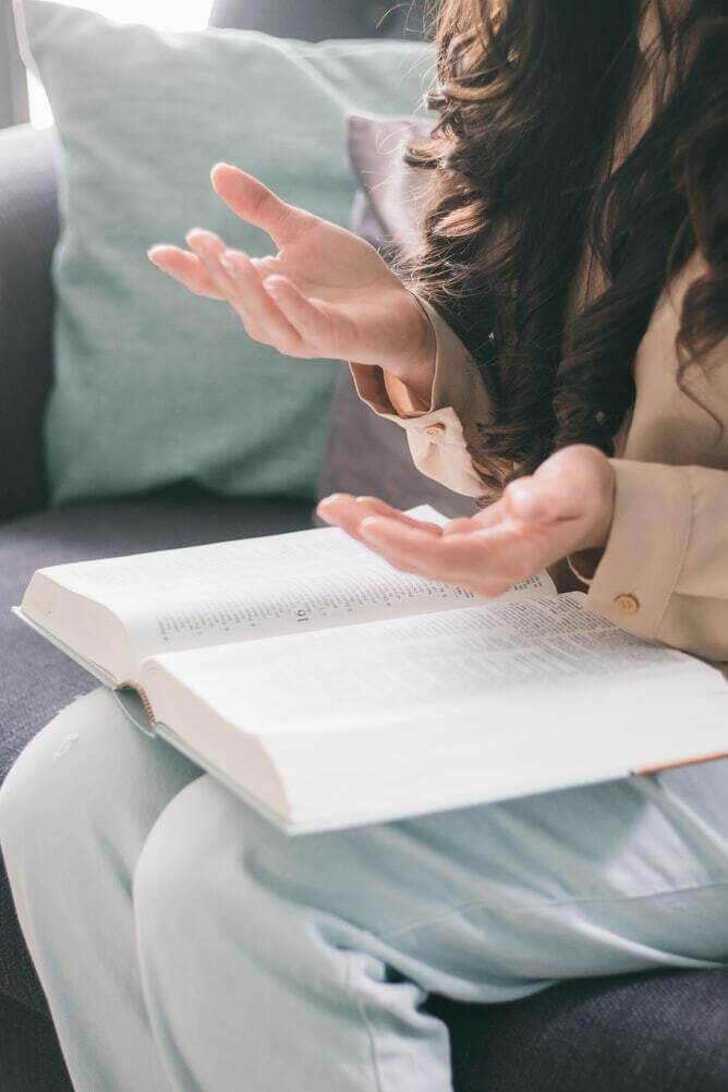 woman reading the bible religion vs spirituality